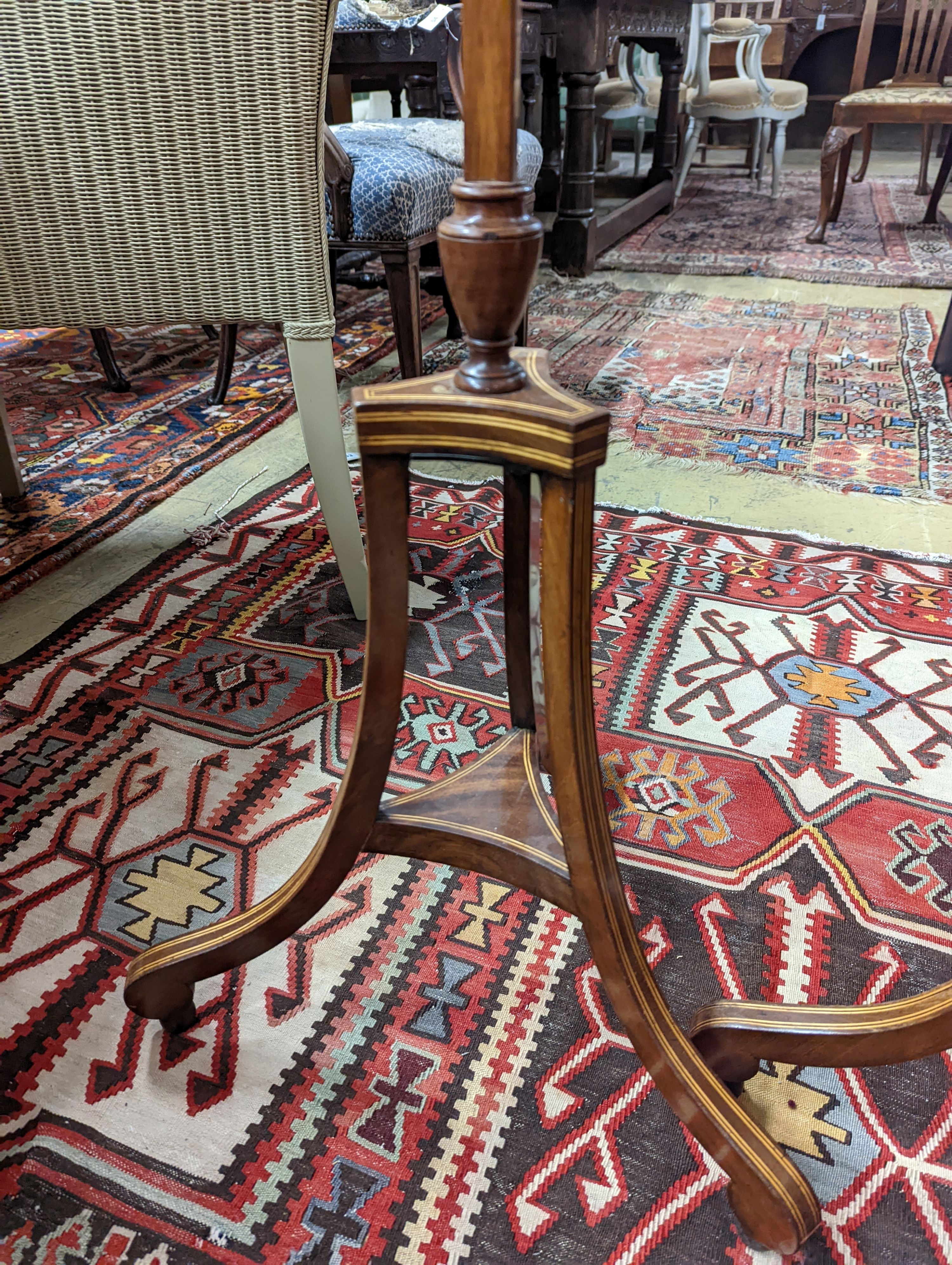 A pair of 19th century mahogany pole screens, with oval silkwork banners, height 148cm